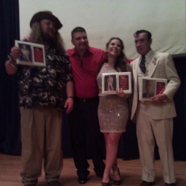 Hall of Fame induction ceremony — Krazy T (far left), Mickie James (center), and Charlie Brown (far right) holding their induction plaques